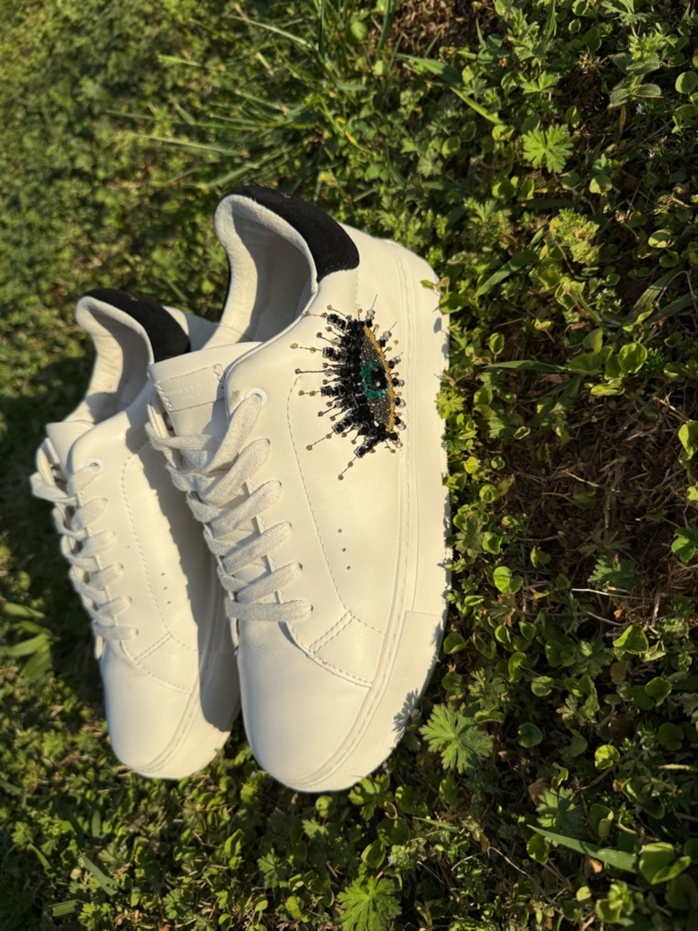 Kurt Geiger White Sneakers with Black Heel and Gold Embellishment